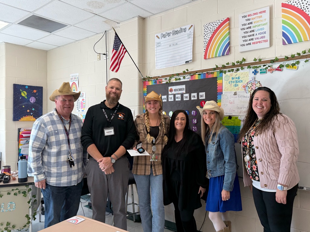 Image of Daisey posing with the Superintendent, district and building administrators. 