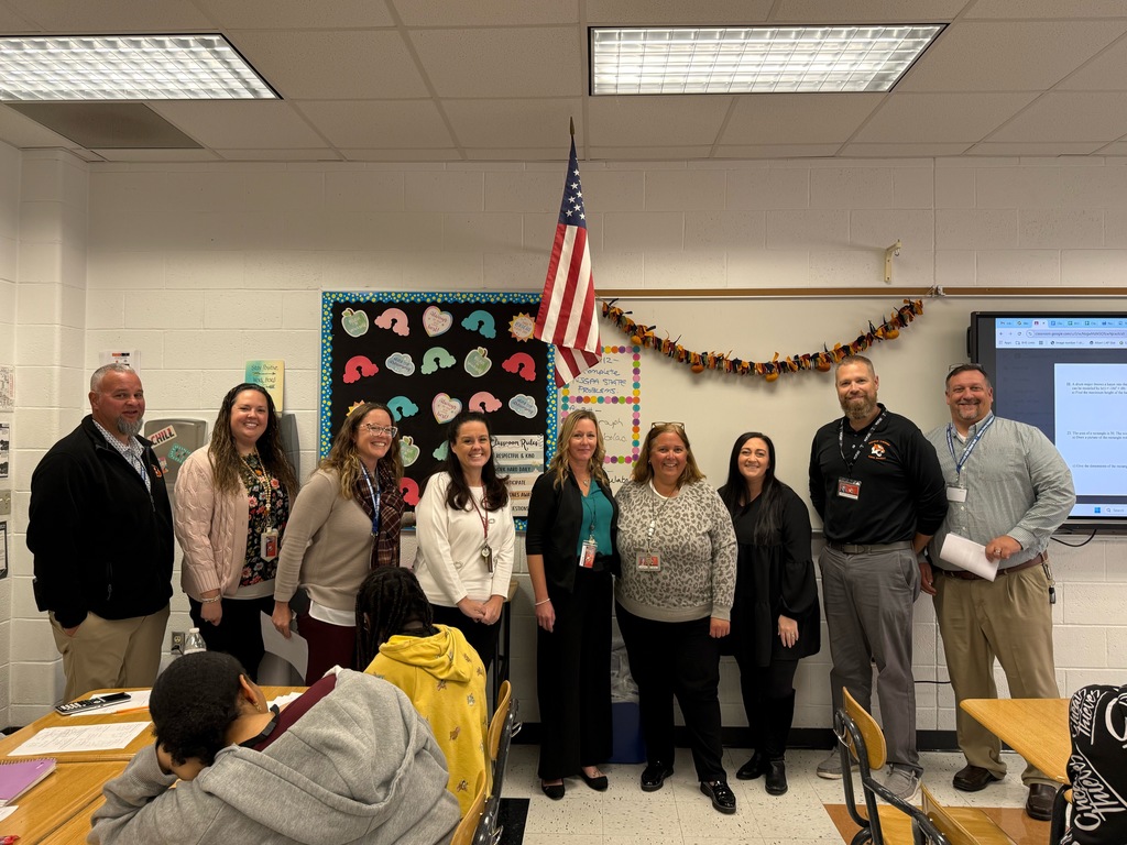 Image of Jacqueline posing with the Superintendent, district and building administrators. 