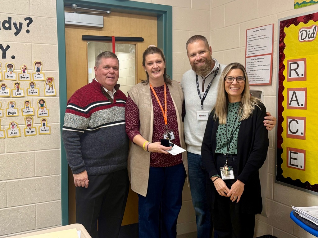 Image of Christine posing with the Superintendent and building administrators. 