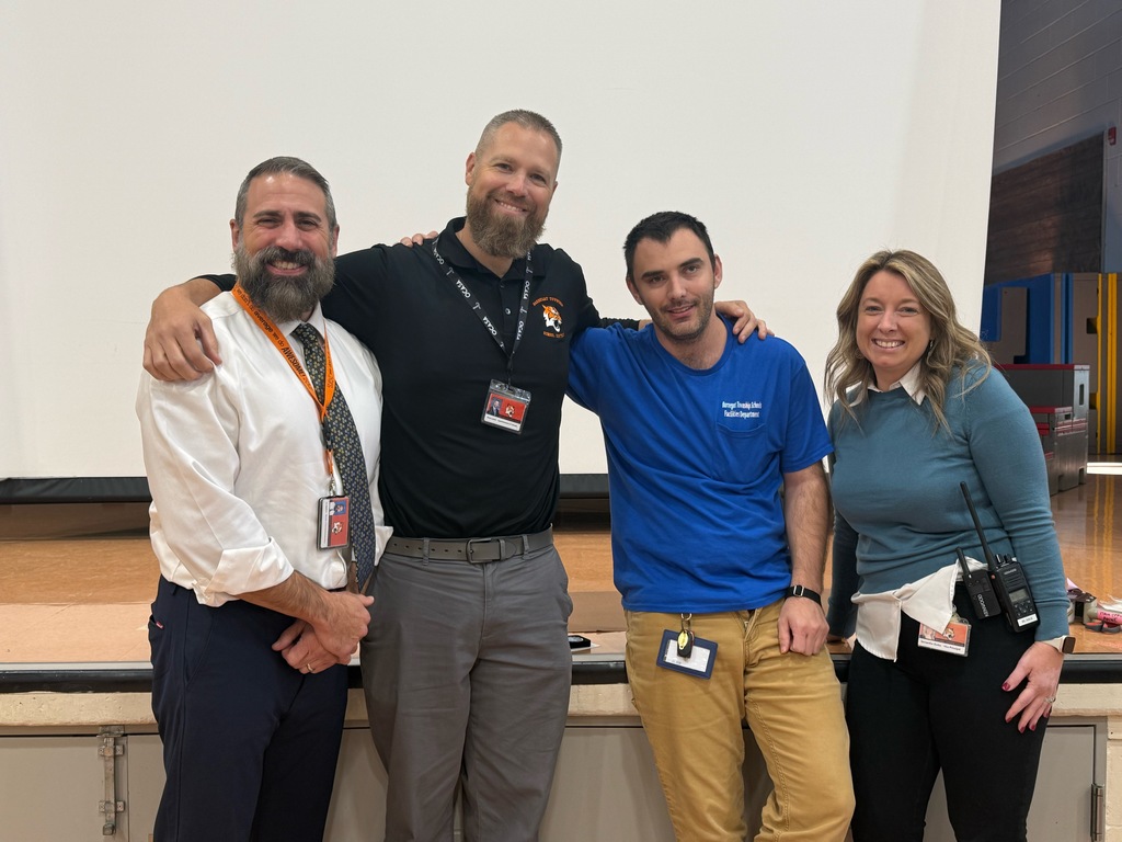 Image of Robert posing with the Superintendent, district and building administrators. 