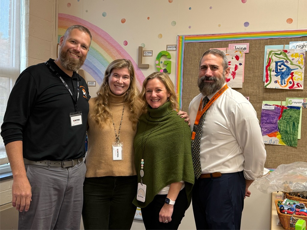 Image of Tara posing with the Superintendent, district and building administrators. 