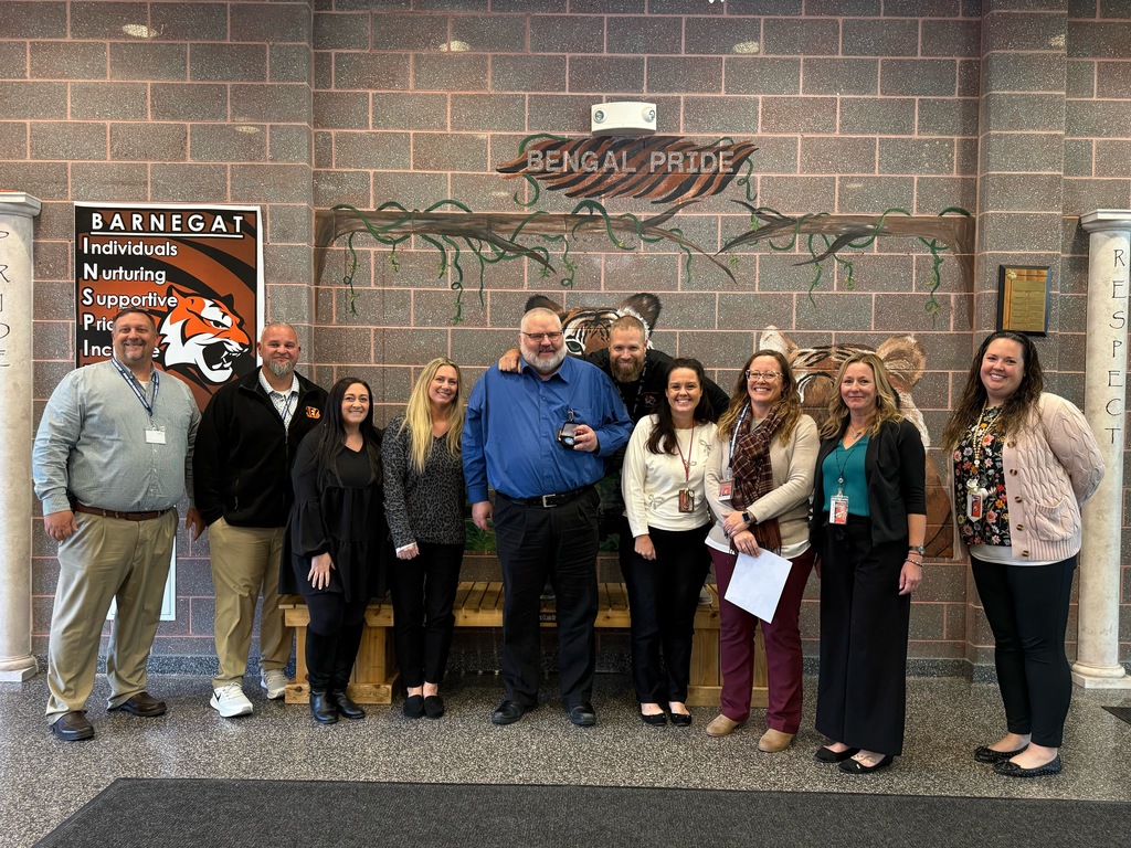 Image of Kelly posing with the Superintendent, district and building administrators. 