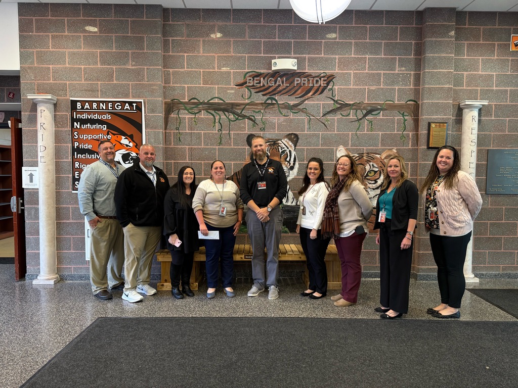 Image of Kristen posing with the Superintendent, district and building administrators.