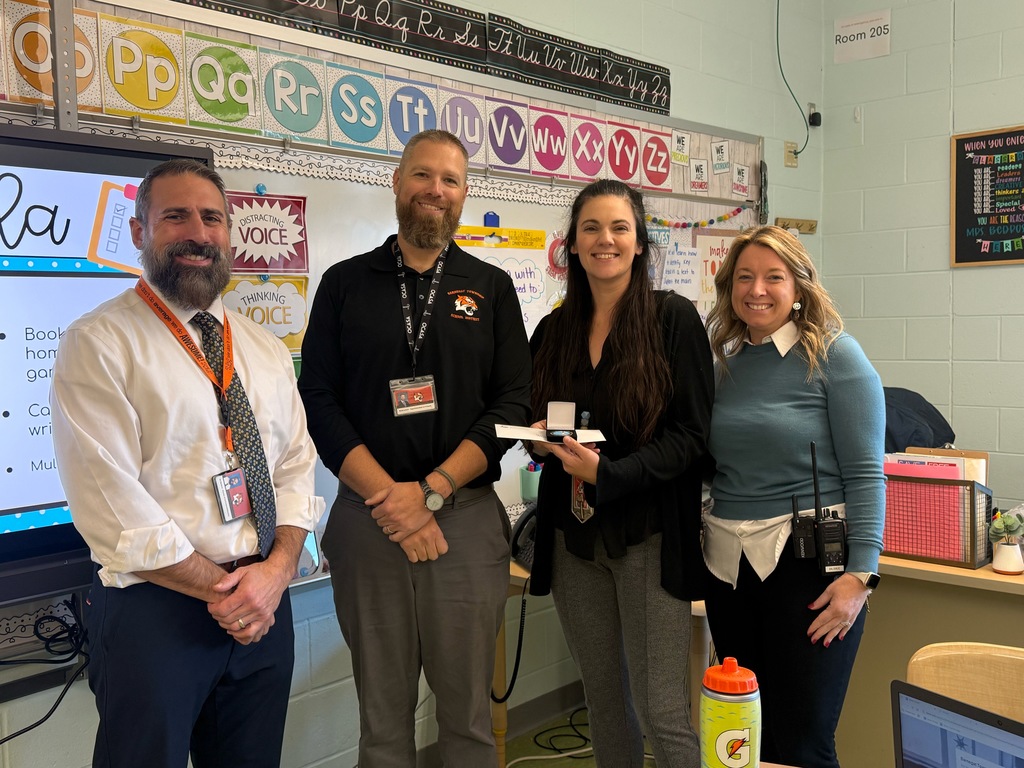 Image of Marissa posing with the Superintendent, district and building administrators. 