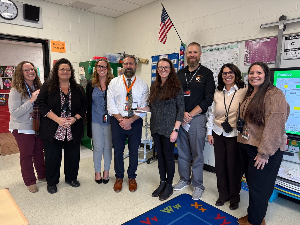 Image of Kimberly posing with the Superintendent, district and building administrators. 