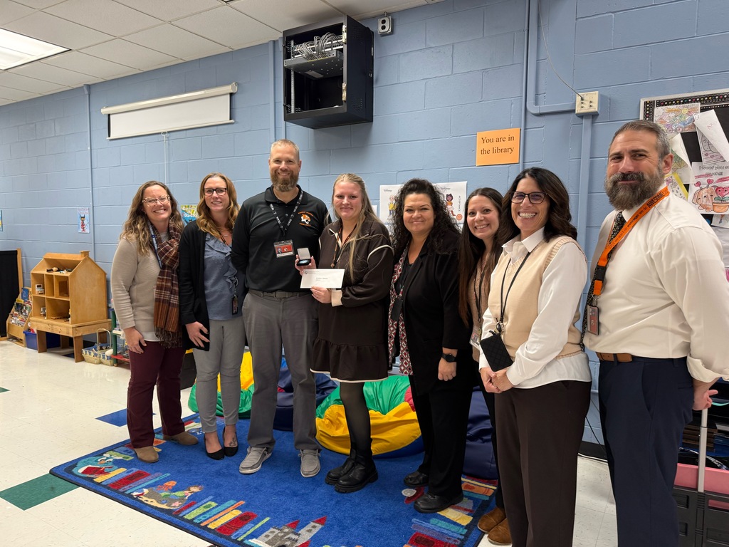 Image of Lindsey posing with the Superintendent, district and building administrators. 