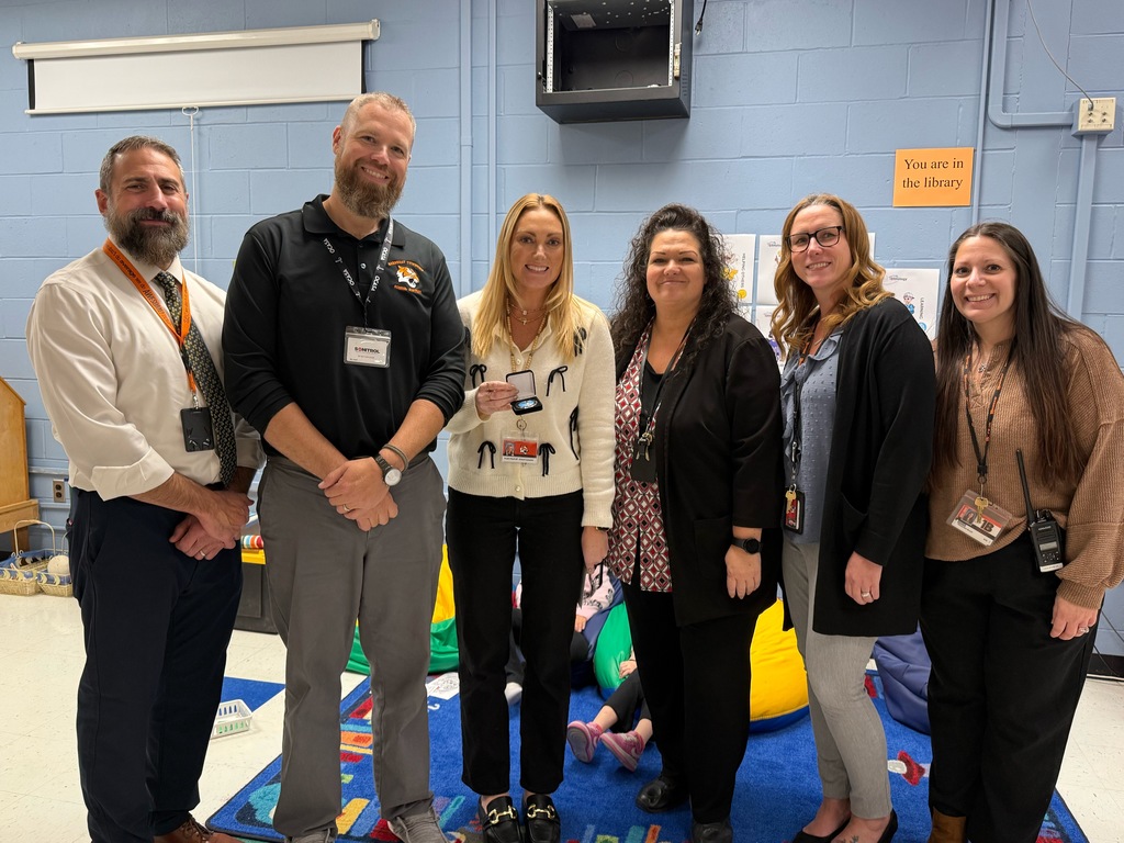 Image of Angela posing with the Superintendent, district and building administrators. 