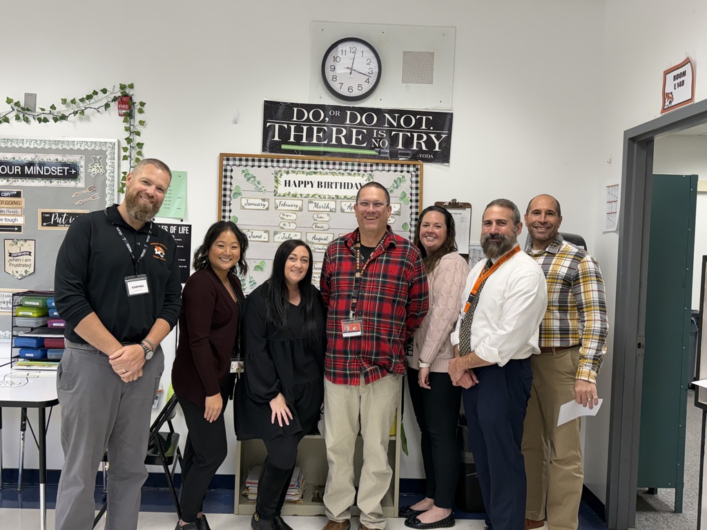 Image of Robert Jorgensen posing with the Superintendent, district and building administrators. 