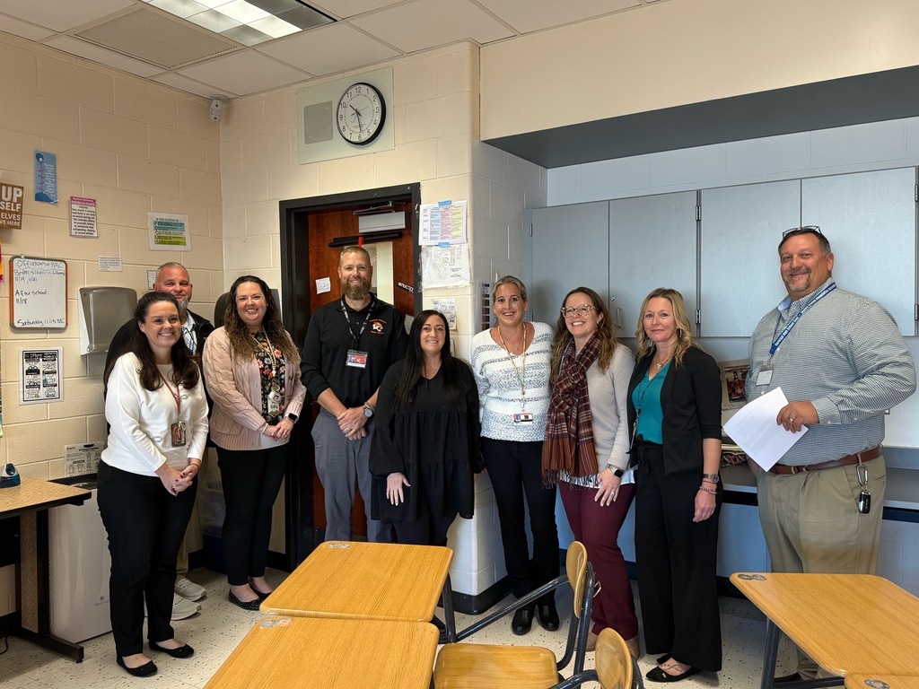 Image of Emily posing with the Superintendent, district and building administrators. 
