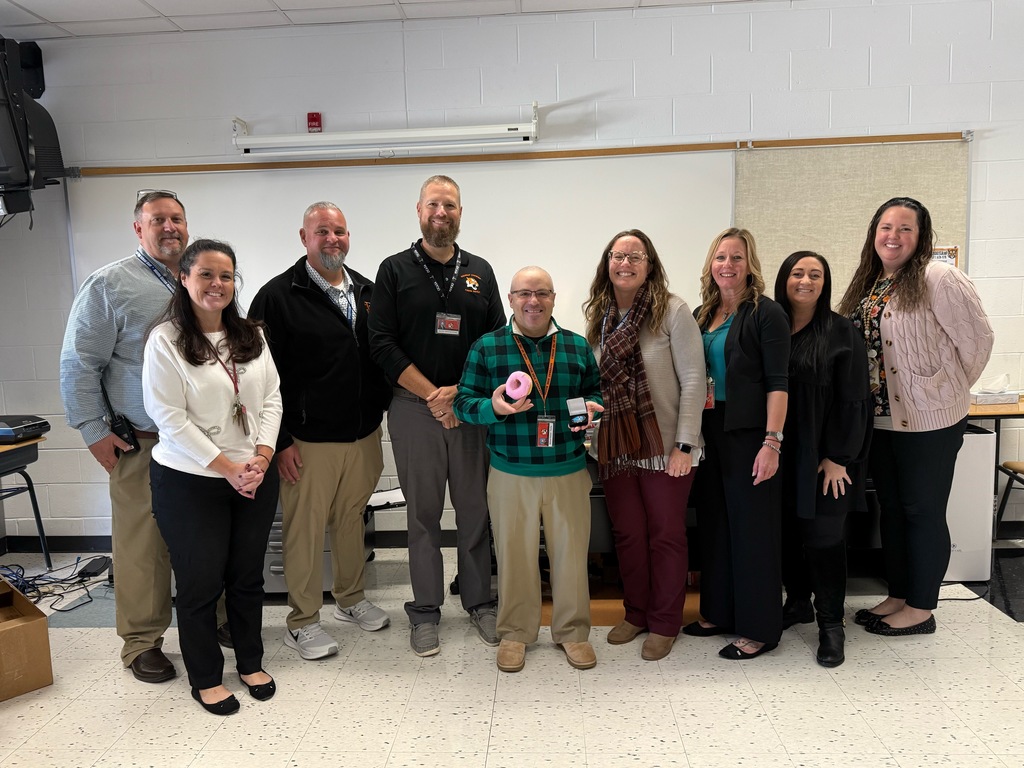 Image of Michael posing with the Superintendent, district and building administrators. 