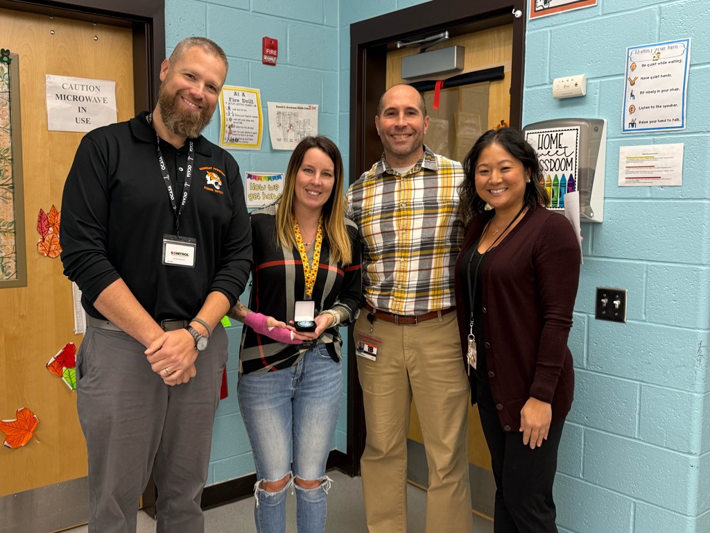 Image of Danielle posing with the Superintendent, district and building administrators. 