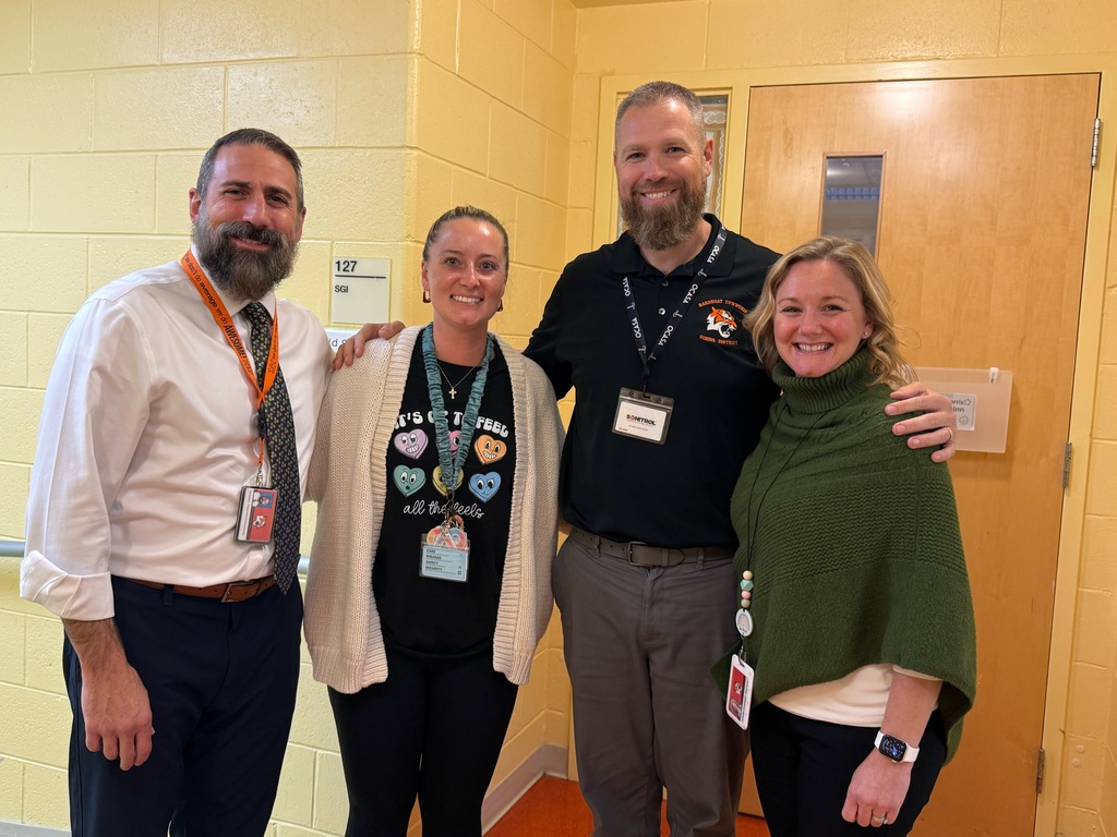 Image of Kyleigh posing with the Superintendent, district and building administrators. 