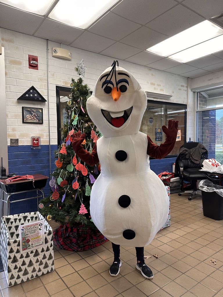 Image of Olaf standing in from of the Collins Giving Tree.