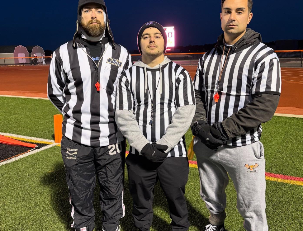 Image of the three staff members in ref gear. 