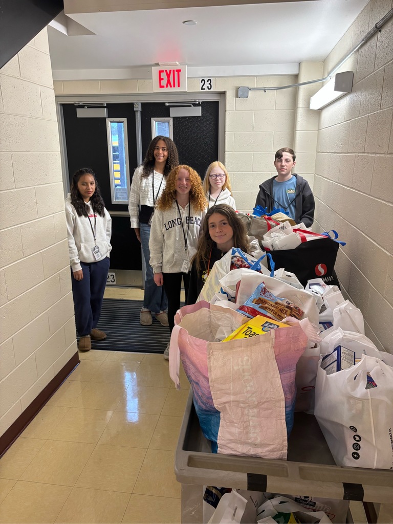 Image of the student council members with all of the food items in bags on a cart. 