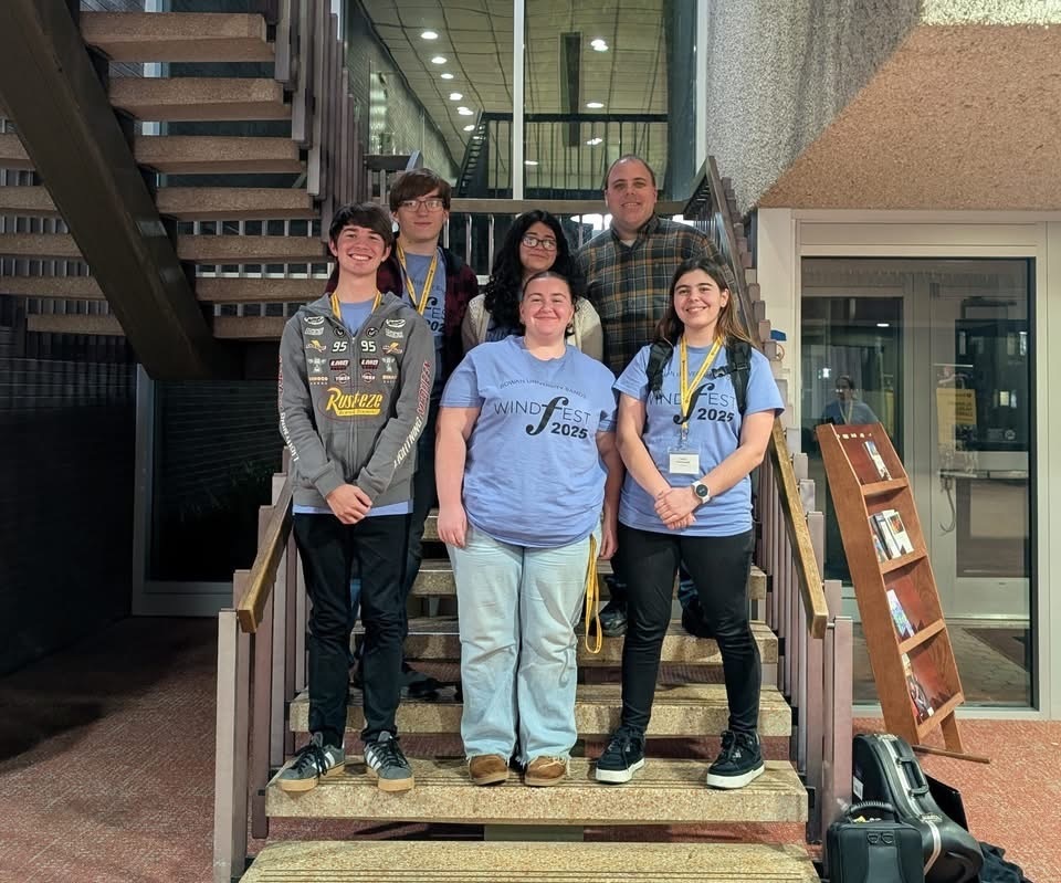 Image of Mr. McGrath, the BHS band teacher, posing with 5 of the students who performed in the Honors Band. 