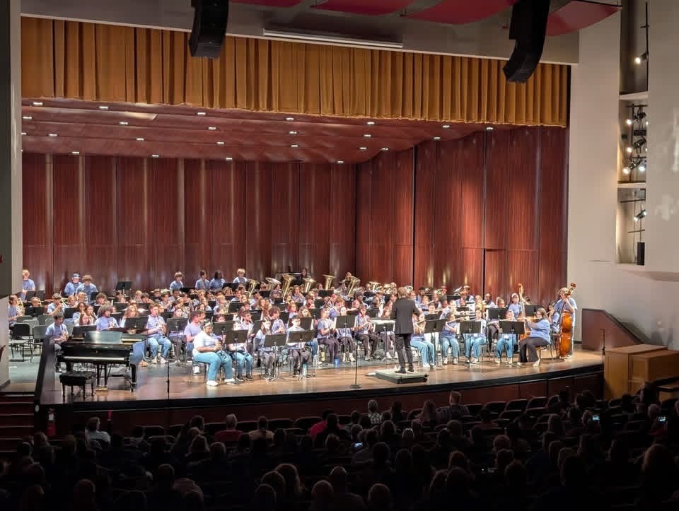 Image of the entire band performing on stage. 