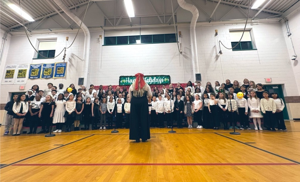 Image of Mrs. Kuntz directing the chorus students as they perform at the Winter Concert. 