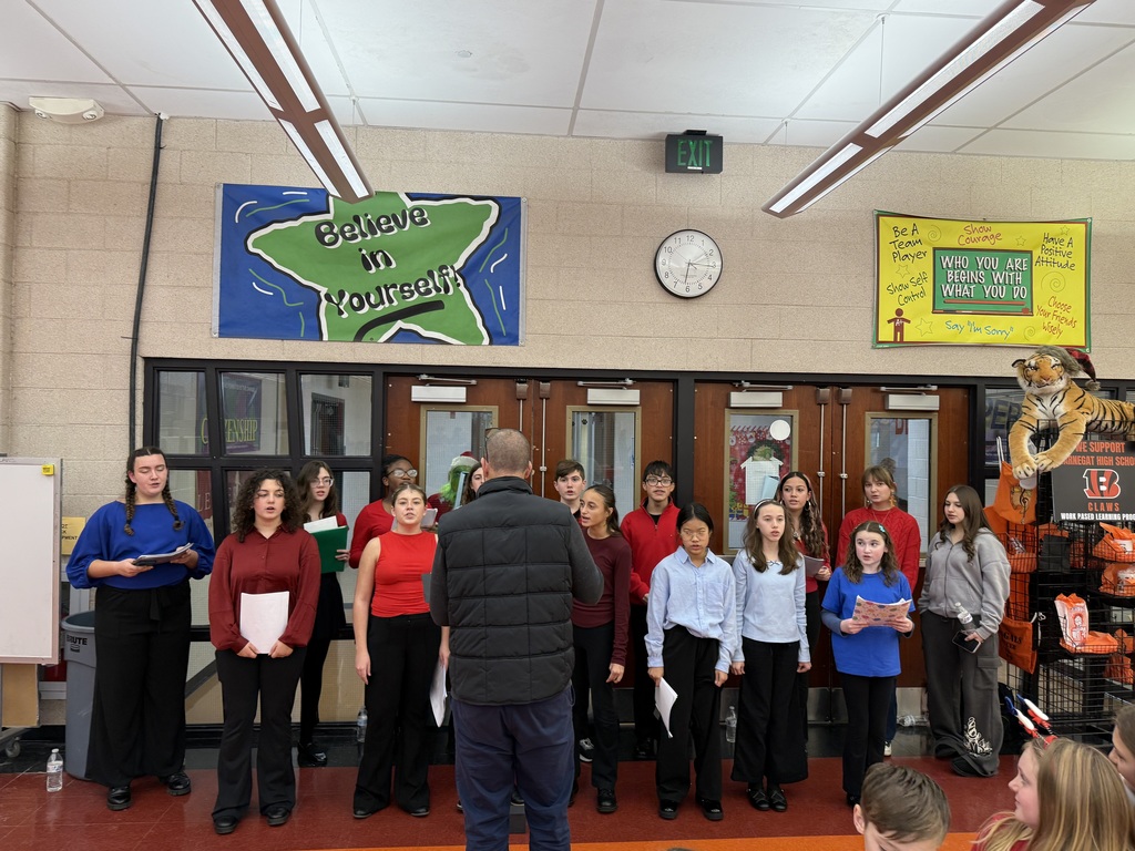 Image of the Bracktones caroling for families in the cafeteria.
