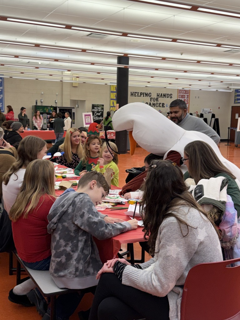 Image of Olaf interacting with families at the coloring table.