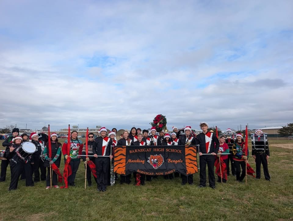 Image of the BHS Marching Band holding their sign and posing for a picture. 