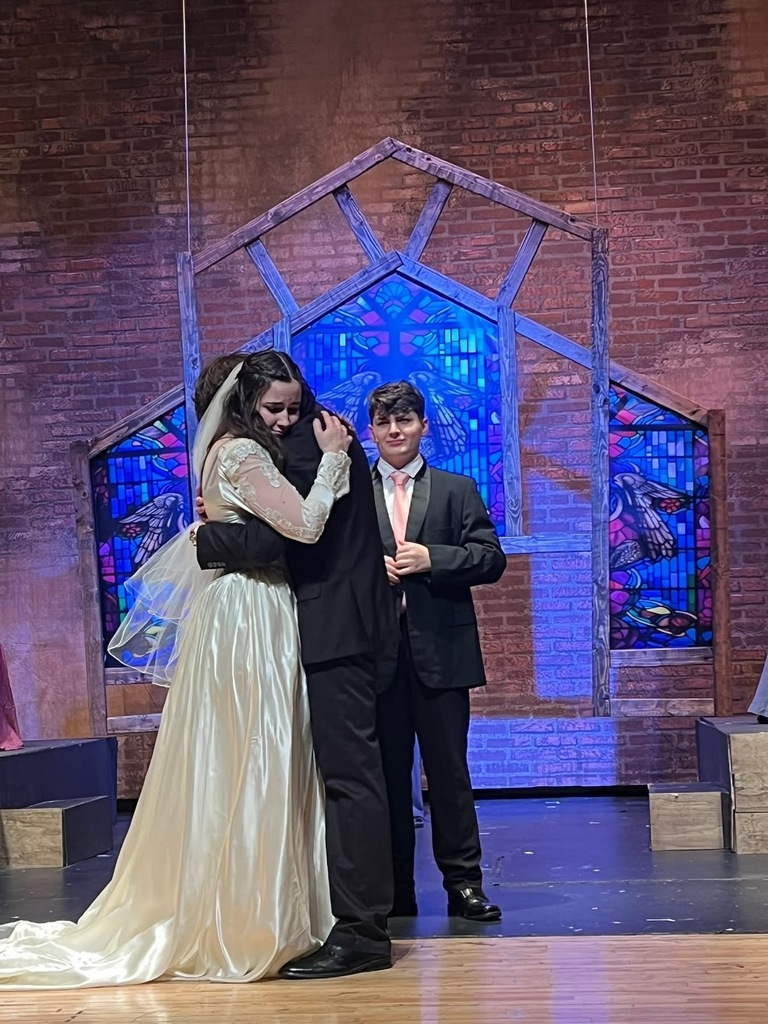 Image of a scene where the actors are embracing. 