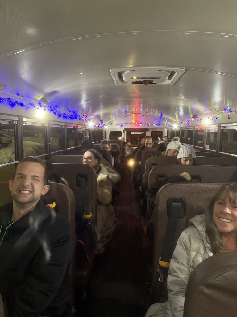 Image of families on the bus waiting for the Holiday Lights Bus Tour to depart. 