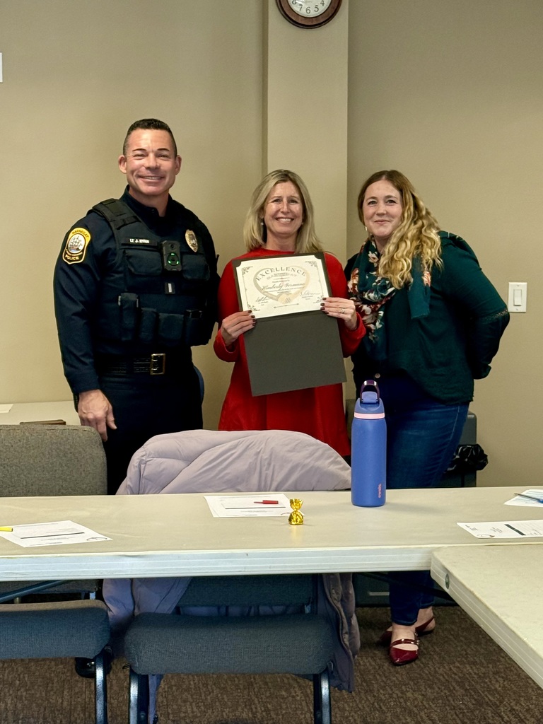 Image of Kim Germano holding a certificate posing with members of the CTC. 