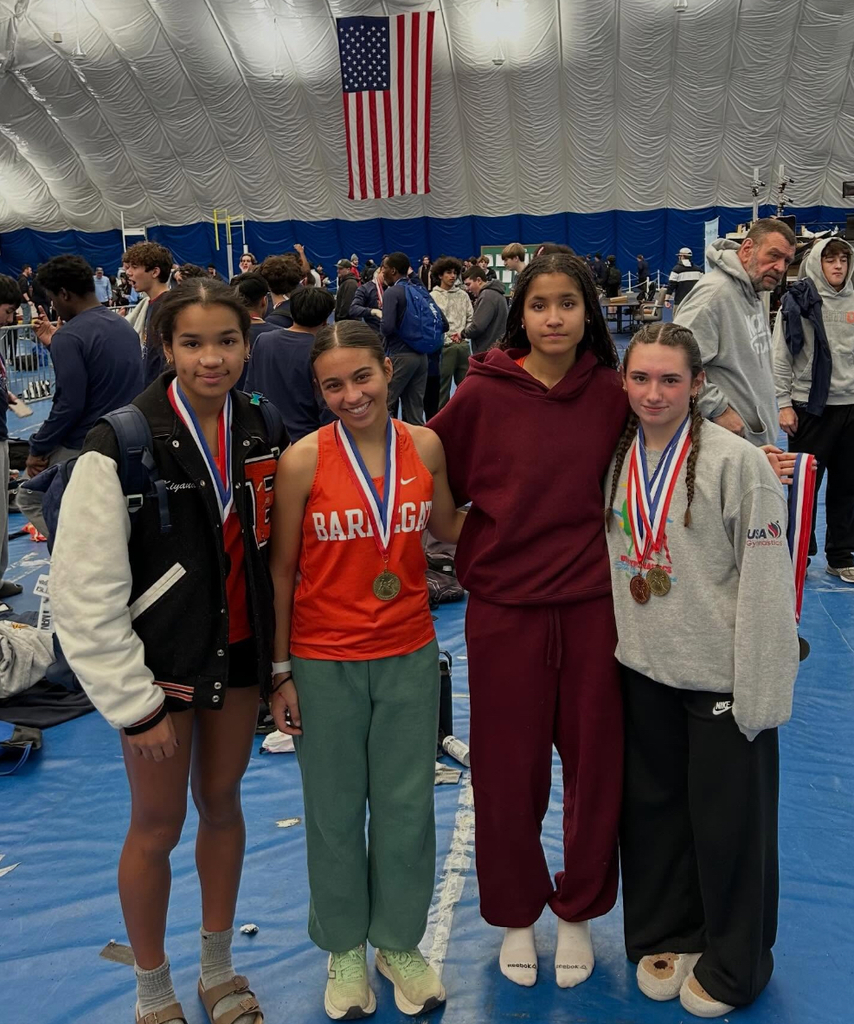 Image of the four girls wearing their medals. 