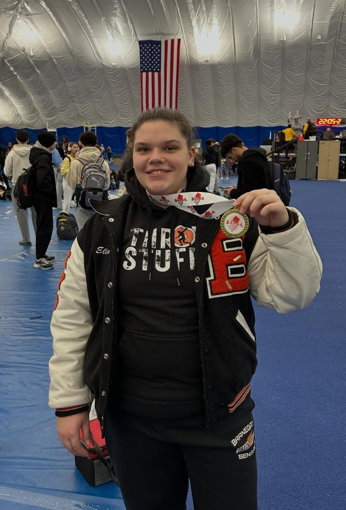 Image of Ellie with her medal around her neck. 