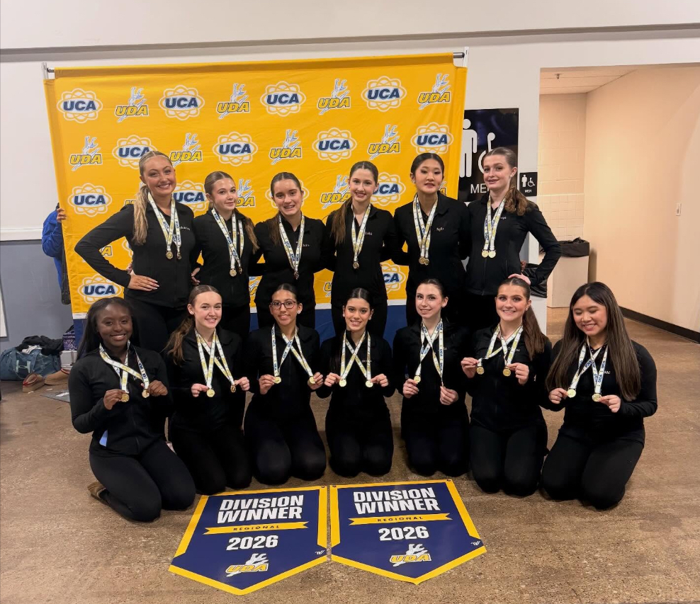 Image of the BHS Dance Team posing with their 1st place banners. 