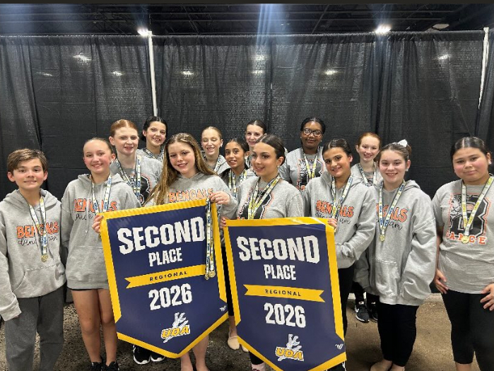 Image of the ROBMS Dance team posing with their 2nd place banners. 