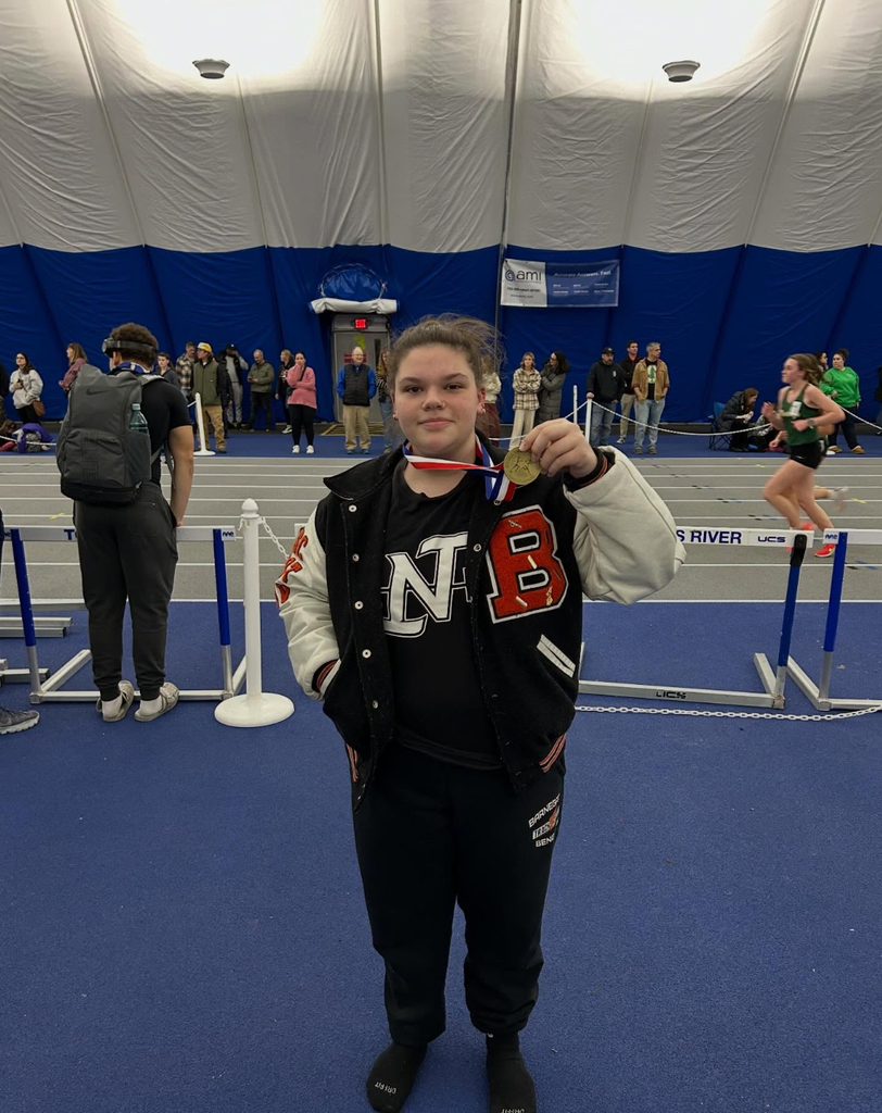 Image of Ellie with the medal around her neck holding it up for the picture. 