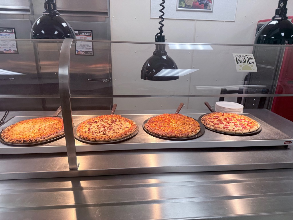 Image of four different pizzas. 