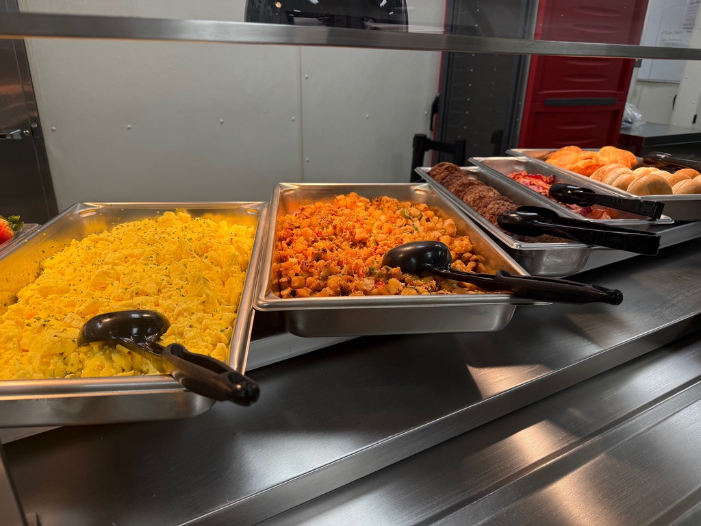 Image of brunch style breakfast including eggs, hashbrowns, sausage, and bacon. 