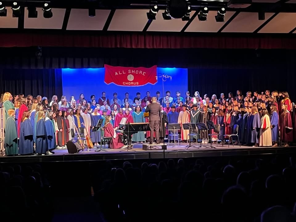 Image of the All Shore Chorus performing on stage. 