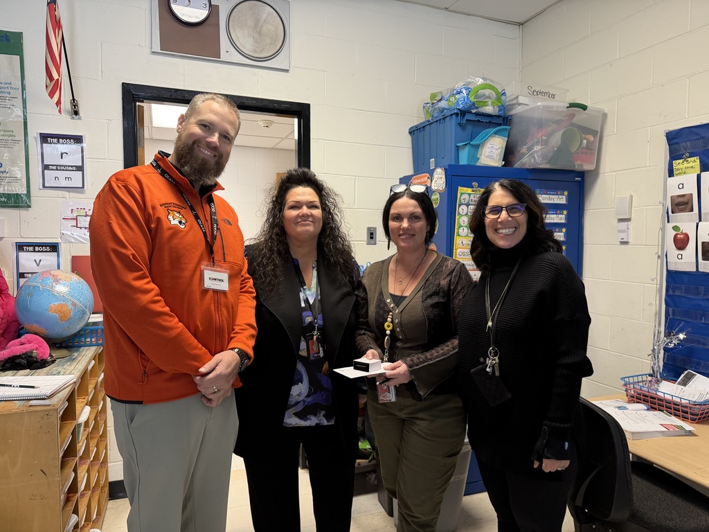 Image of Angela posing with the Superintendent and building administrators.