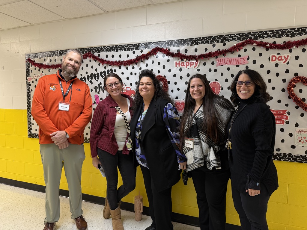 Image of Stacey posing with the Superintendent and building administrators.