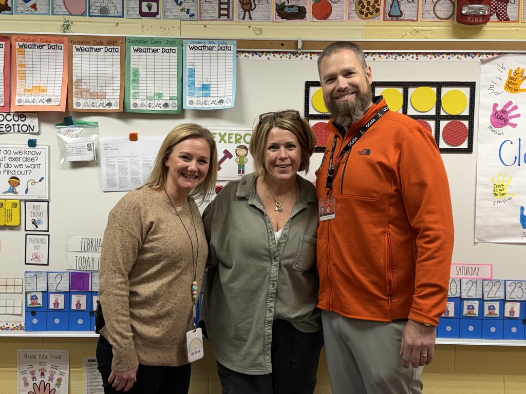 Image of Jennifer posing with the Superintendent and Principal.