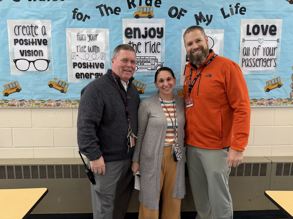 Image of Christine posing with the Superintendent and Principal.