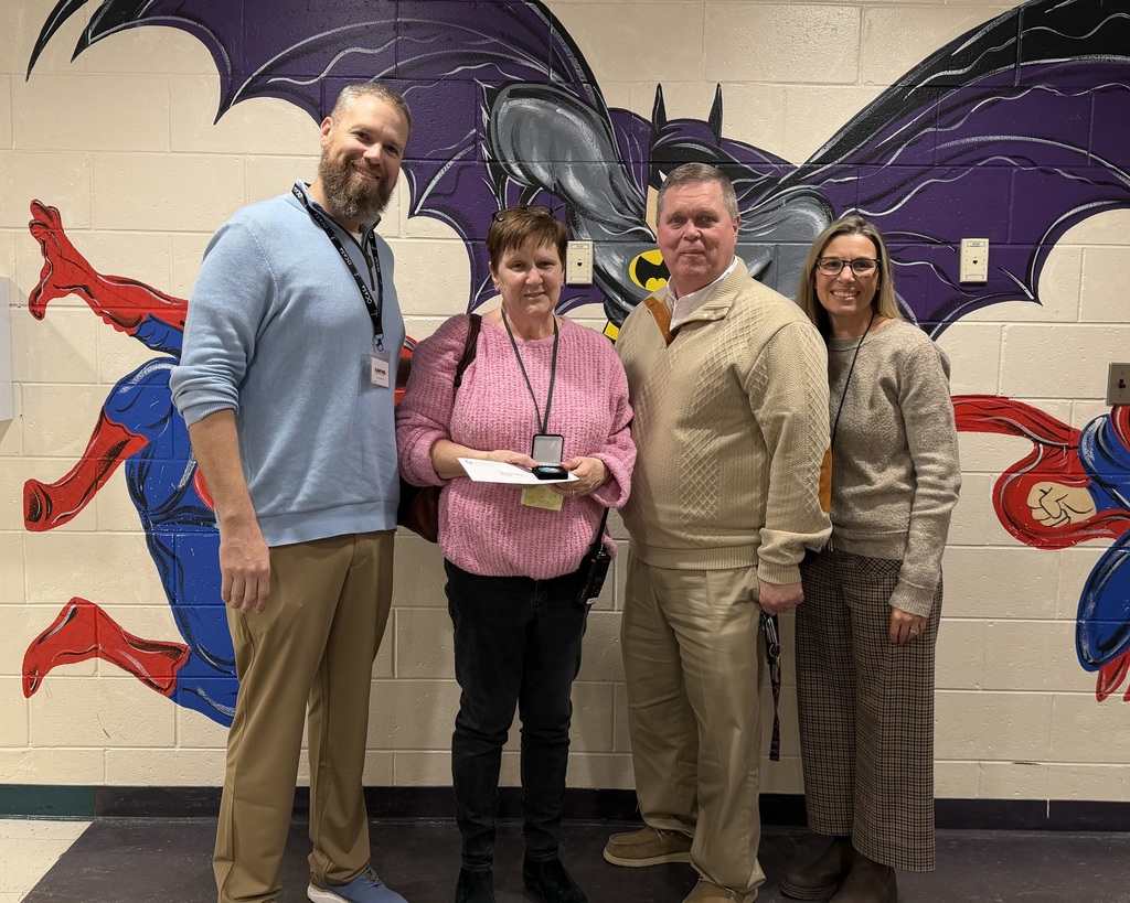 Image of Christine posing with the Superintendent and building administrators.