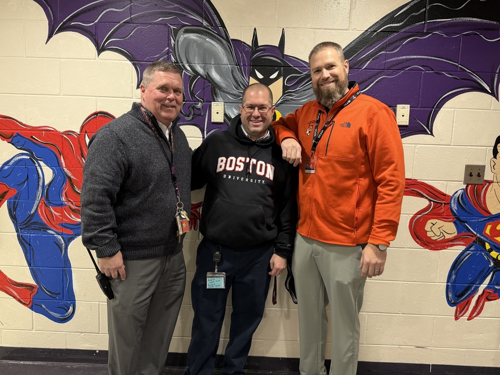 Image of Anthony posing with the Superintendent and Principal.