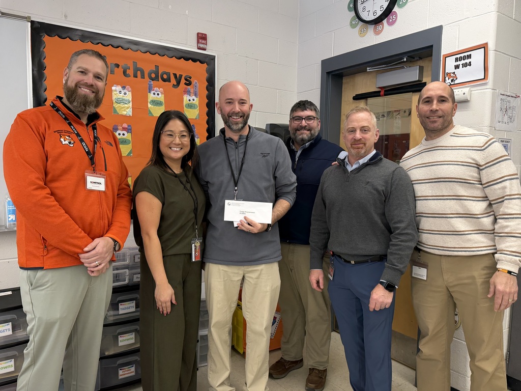 Image of Gregg posing with the Superintendent and building administrators. 