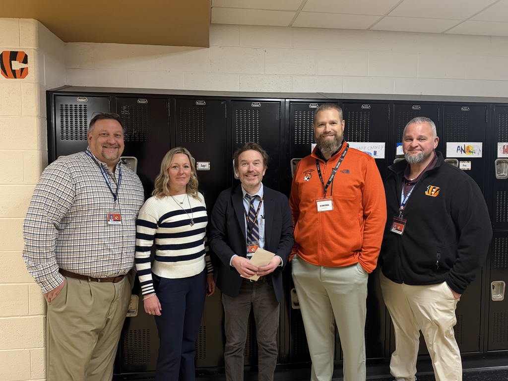 Image of Brendan posing with the Superintendent and building administrators. 