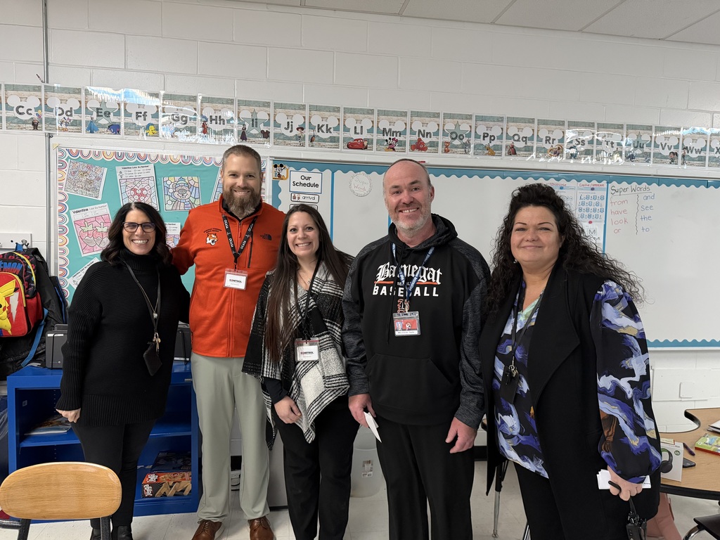 Image of Michael posing with the Superintendent and building administrators.