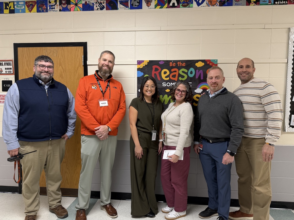 Image of Jessica posing with the Superintendent and building administrators.