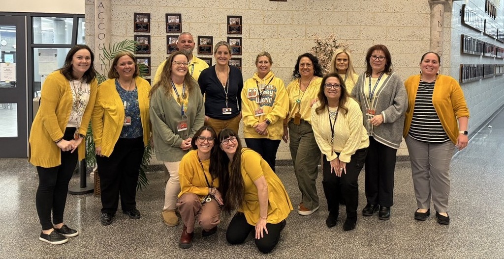 Image of BHS staff posing wearing yellow. 