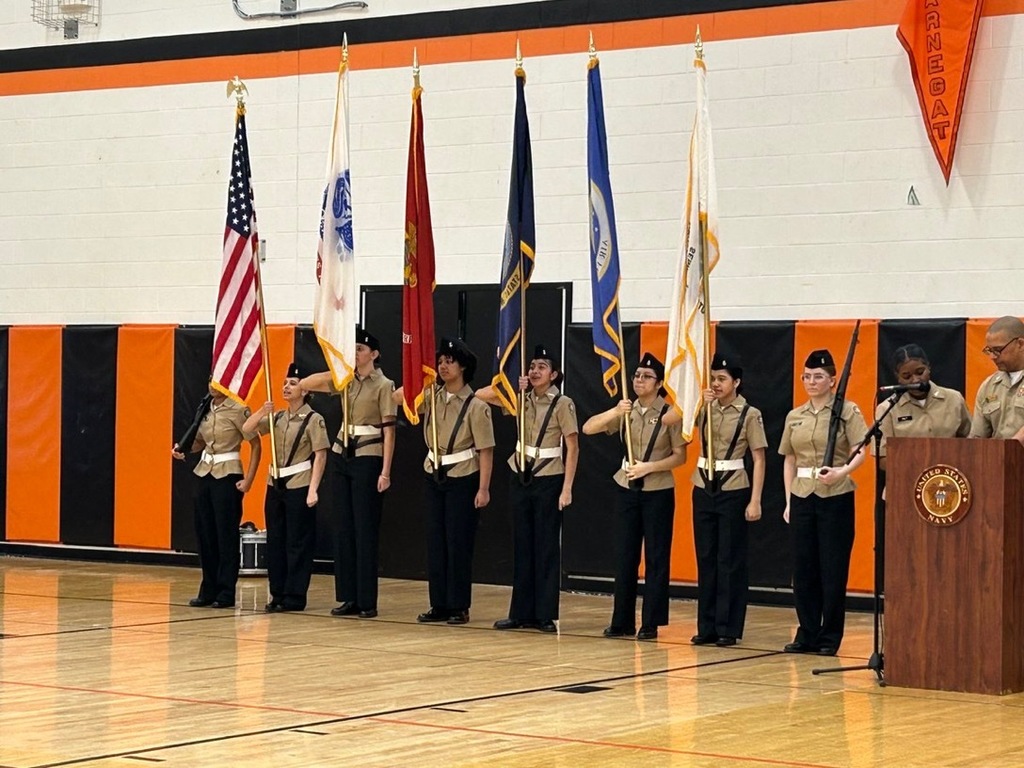 Image of the JROTC members presenting arms. 