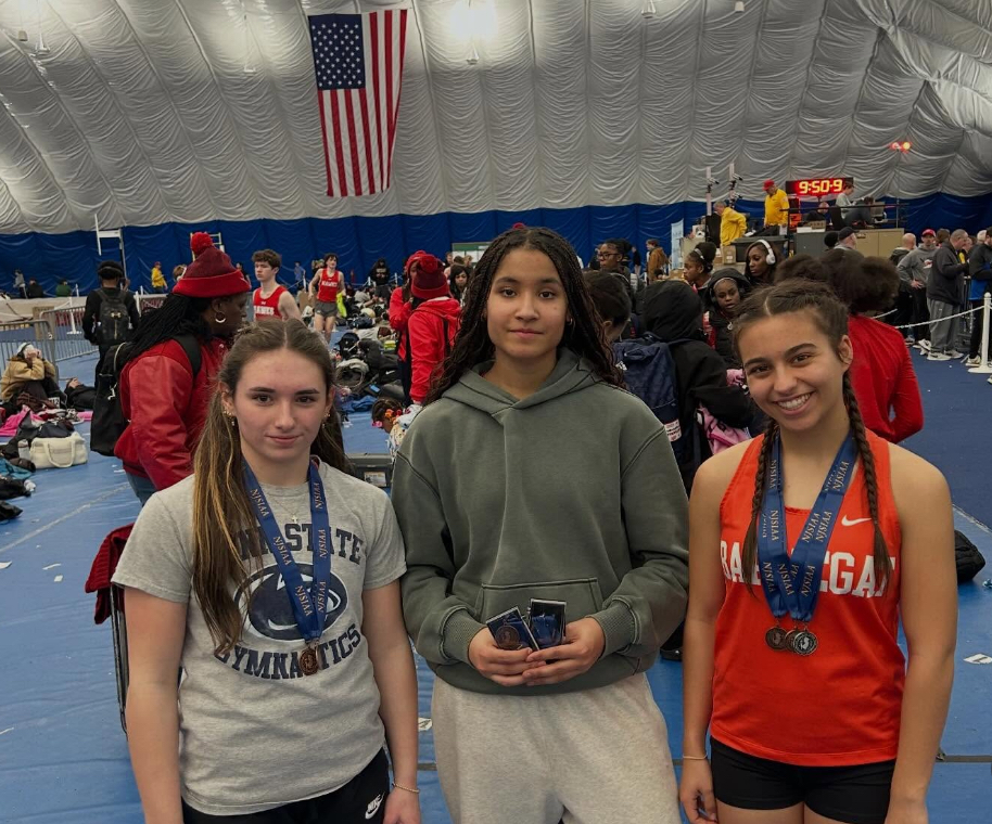 Image of Reagan, Amaya, and Angelina posing together. Raegan and Angelina are wearing medals around their necks and Amaya is holding hers in her hands.