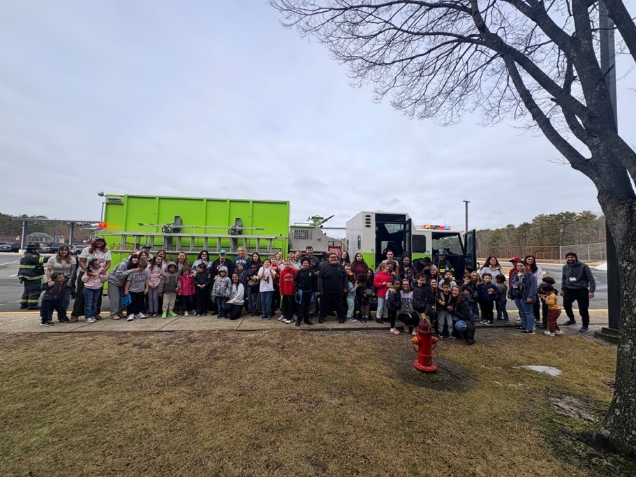 Image of the ACES students and staff posing in front of a fire truck with Barnegat fire fighters. 
